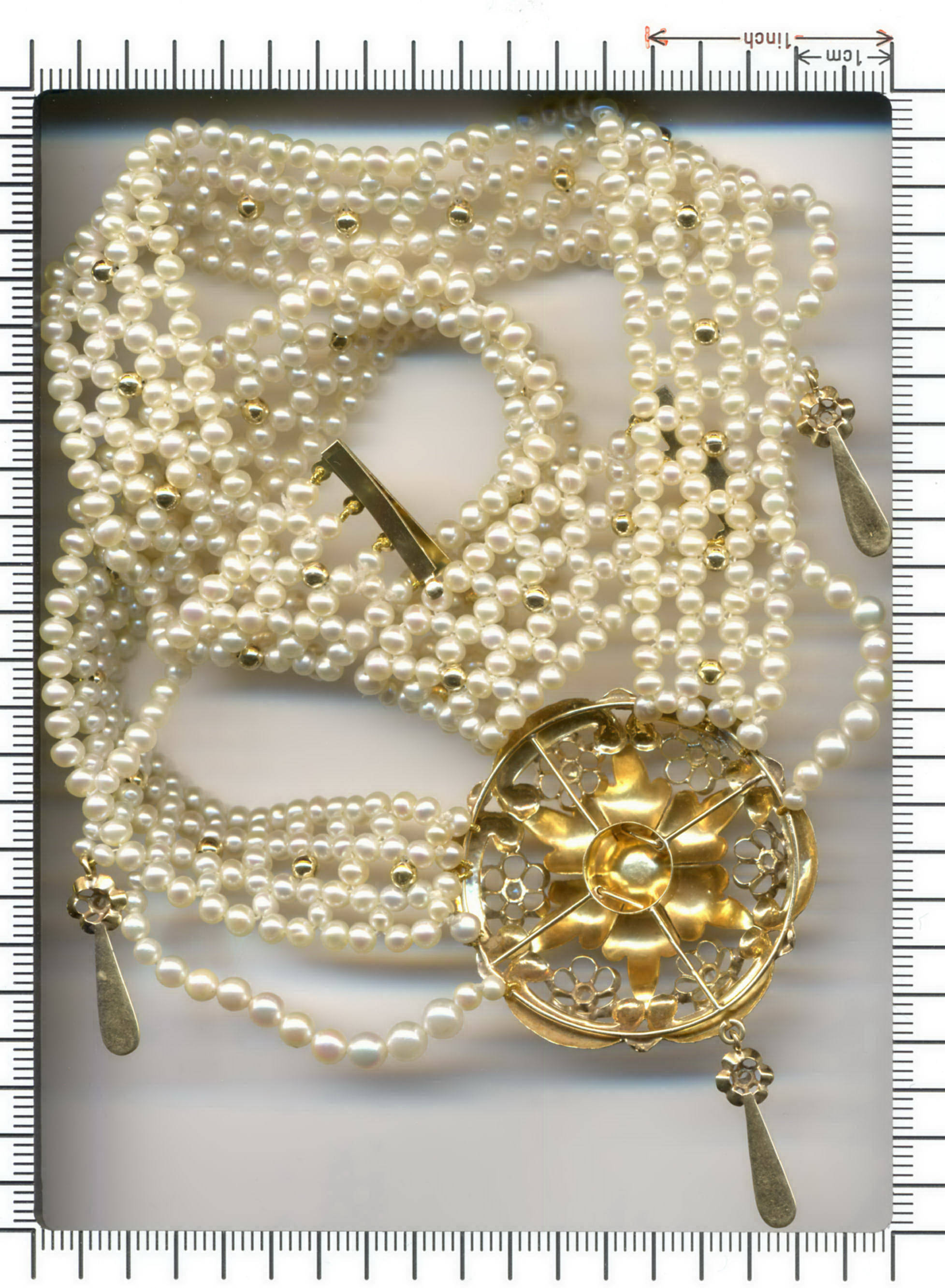 Elegant pearl string necklace with Victorian center piece set with diamonds